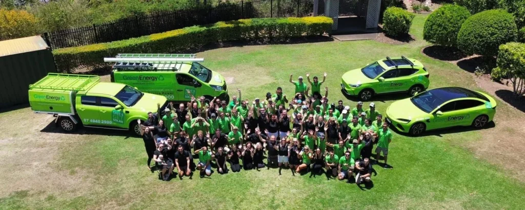 Green Energy Technologies solar panel installers team celebrating outdoors, showcasing their commitment to renewable energy solutions.