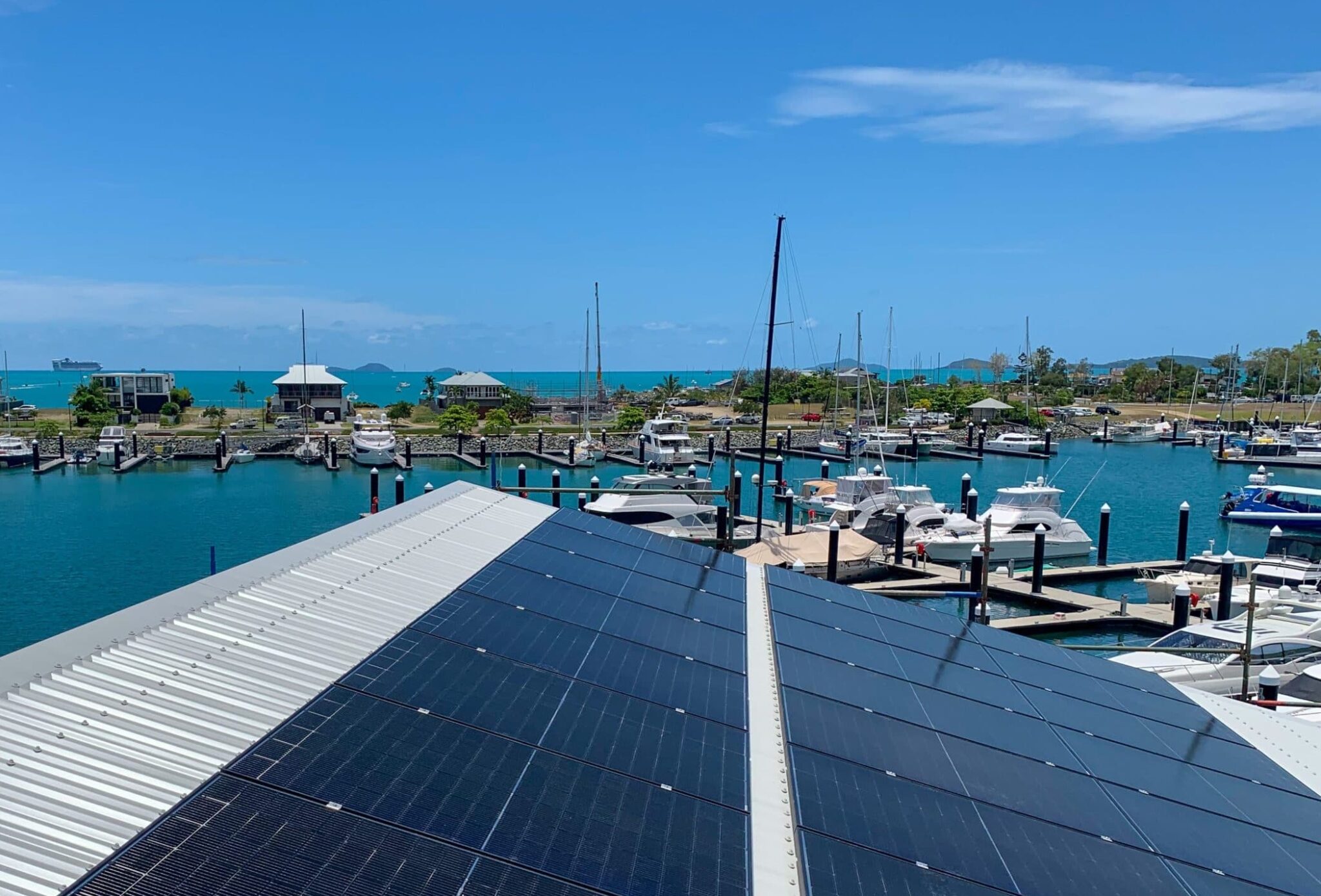 Commercial solar panel installation on a metal roof at a marina, harnessing solar energy for sustainable power. Solar energy installers whitsundays. Solar energy service areas.