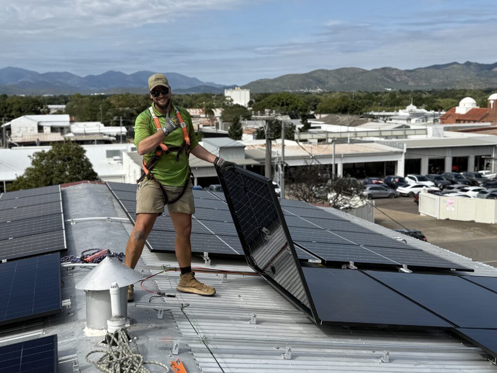 Green Energy Technologies team – #1 solar installers in North QLD – installing solar panels on a roof.