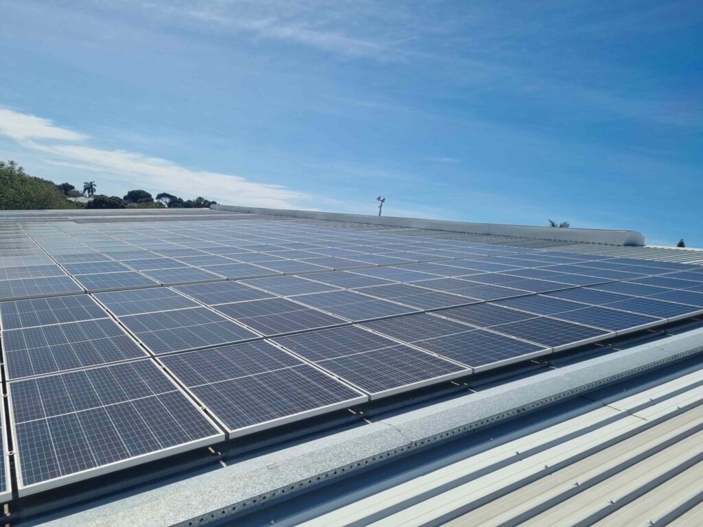 sun hitting commercial solar panels