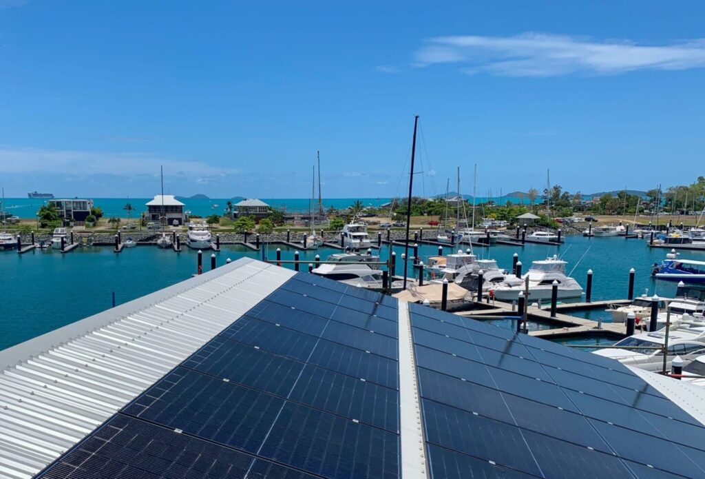 Commercial solar panel installation on a metal roof at a marina, harnessing solar energy for sustainable power. Solar energy installers whitsundays. Solar energy service areas.