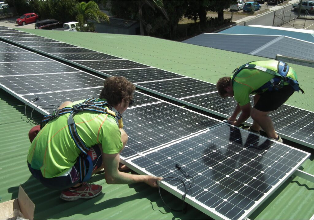 Green Energy Technologies Whitsundays Installers working on solar panels on green roof
